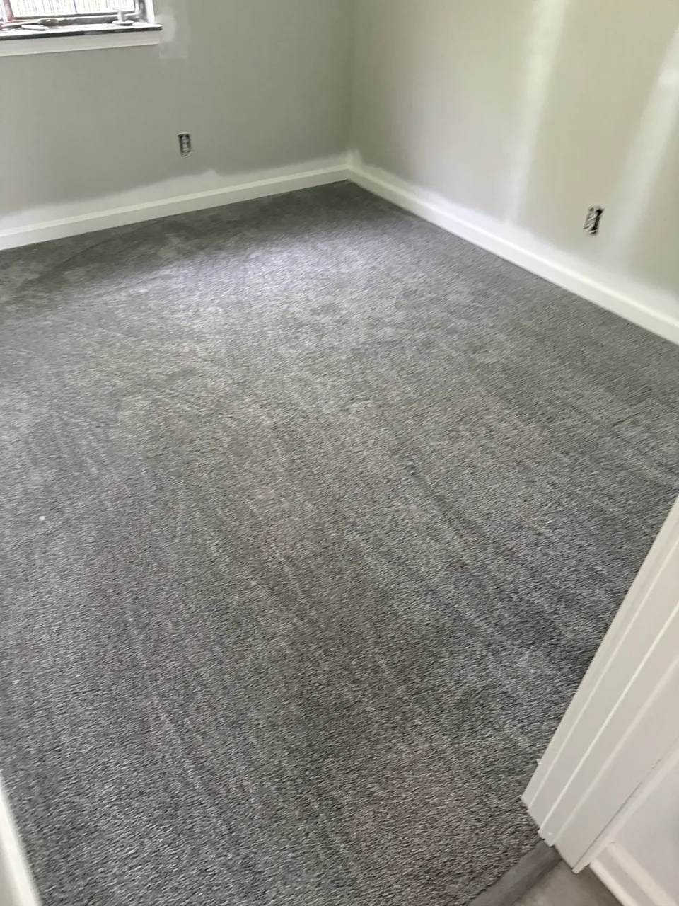 Carpeted residential room near project completion