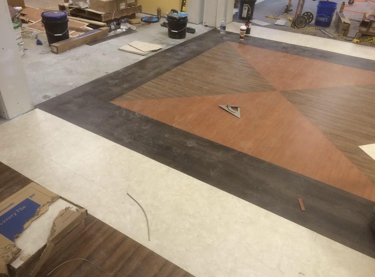 Patterned floor layout with installation tools visible during work
