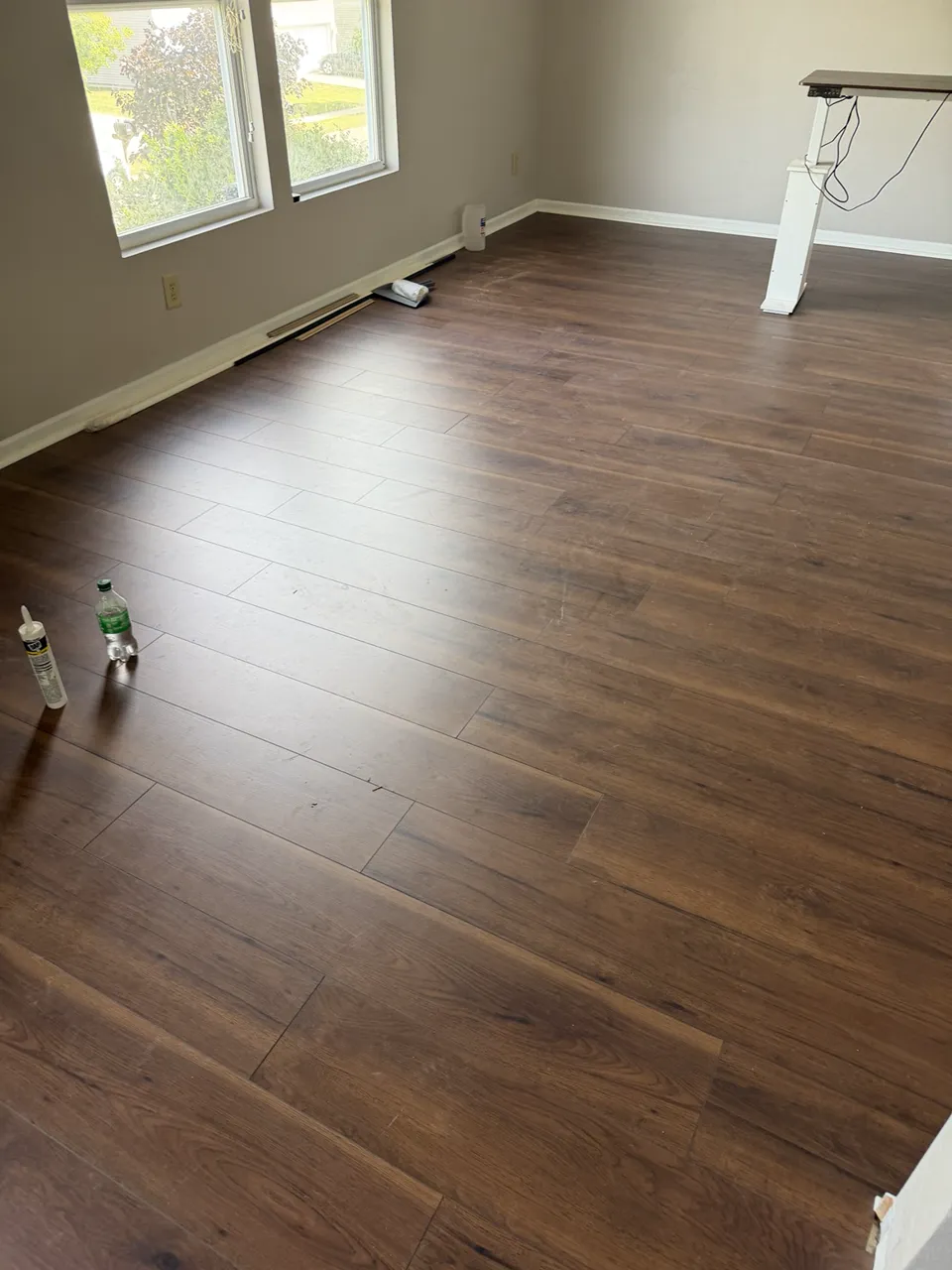 Warm wood-look flooring across an open residential room